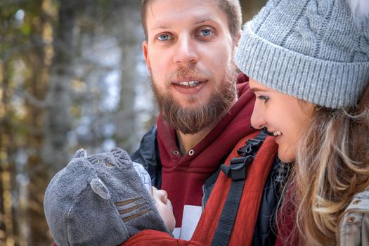 Portrait of young family walking on holiday weekend in the winter outdoor.