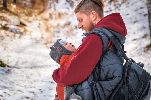 Lifestyle portrait of father an his baby son while walking outdoor.