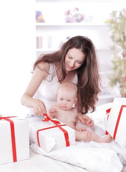 young mother unties the ribbon on the gift boxes.holiday concept