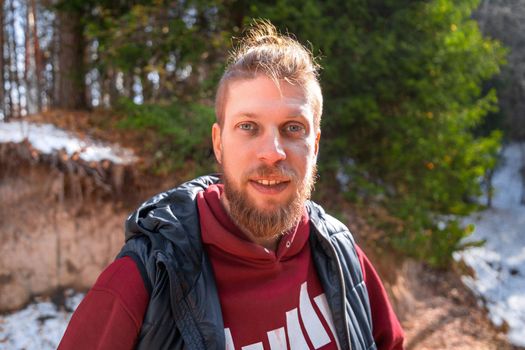 Outdoor portrait of blond hipster man in nature.