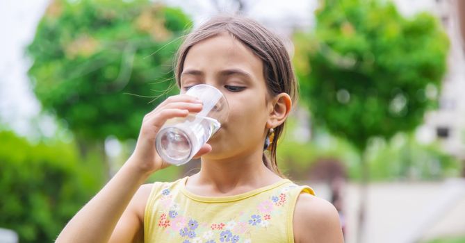 children drink clean water in nature.selective focus.nature