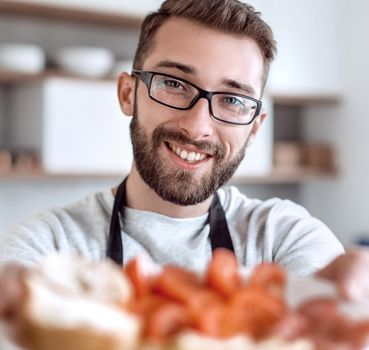 plate of sandwiches in the hands of an attractive man . photo with copy space