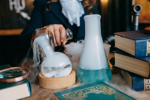 Schoolgirl perform chemical experiments. Flasks with solutions and chemical formulas on the blackboard in the school classroom. Back to school. School and preschool education.