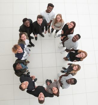 group of young successful people stands around in the office