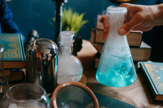 Schoolgirl perform chemical experiments. Flasks with solutions and chemical formulas on the blackboard in the school classroom. Back to school. School and preschool education.