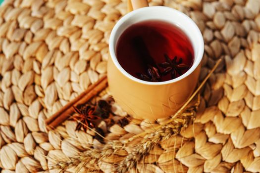 Karkade tea in an orange cup with autumn attributes. The concept of the autumn season, natural colors. Red fruit tea.