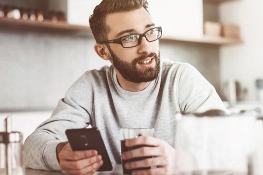 close up. attractive man reading e-mails during Breakfast