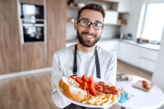 plate of sandwiches in the hands of an attractive man . photo with copy space