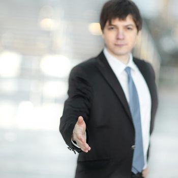 confident businessman holding out hand for a handshake.the concept of partnership