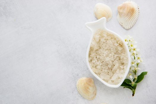 Concept of Spa-cosmetic and cosmetic procedures. Spa-sea salt in white dishes and seashells on light concrete background. The concept of a waste-free lifestyle. copyspase flatlay.