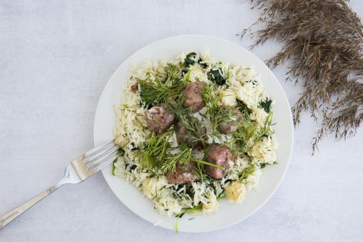 Swedish meatballs with dill, topped with celery and spinach rice. Cooking at home, home-cooked food.