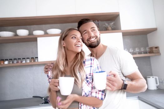 close up. young couple in love in the kitchen in a good morning