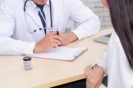 Doctor in professional uniform examining patient at hospital or medical clinic. Health care , medical and doctor staff service concept.