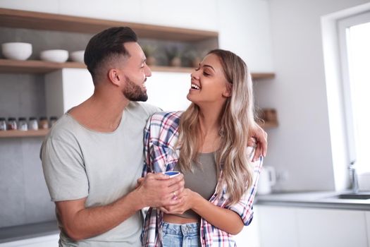 close up. happy young couple in kitchen in good morning time