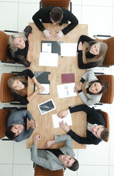 top view. young business team sitting at a table and looking at the camera. business concept