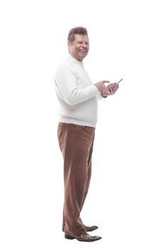 side view. casual man reading the correspondence on his smart phone . isolated on a white background