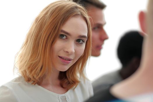 close up. portrait of a beautiful young woman on the background of her friends