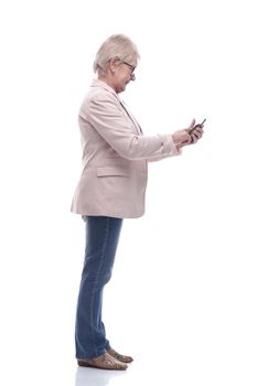 side view. cute senior woman talking on her smartphone . isolated on a white background