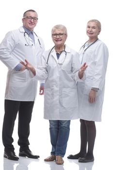 in full growth. friendly female doctor and her colleagues standing together. isolated on a white background