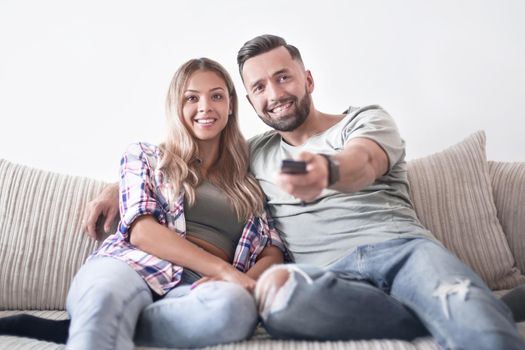 Young couple enjoying themselves on the sofa in the living room. photo with copy space