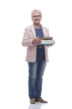 in full growth. senior woman with a stack of books .isolated on a white background