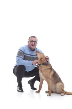 in full growth. smiling man with his favorite dog. isolated on a white background