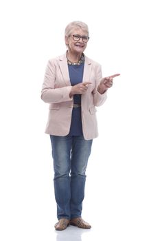 in full growth. attractive senior woman pointing the direction .isolated on a white background