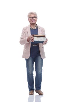 in full growth. smiling old lady with a stack of books .isolated on a white background