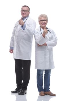 in full growth. two medical colleagues showing thumbs up. isolated on a white background