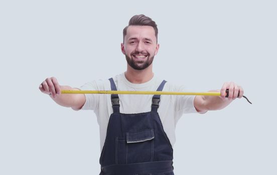 in full growth. smiling man with construction tape measure. isolated on white background