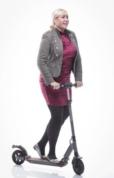 in full growth. attractive happy woman with an electric scooter. isolated on a white background.