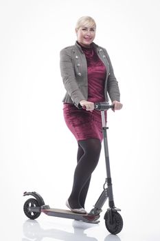 in full growth. modern young woman with an electric scooter. isolated on a white background.