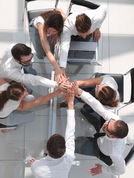 top view.employees of the company connecting the palms together.the concept of teamwork