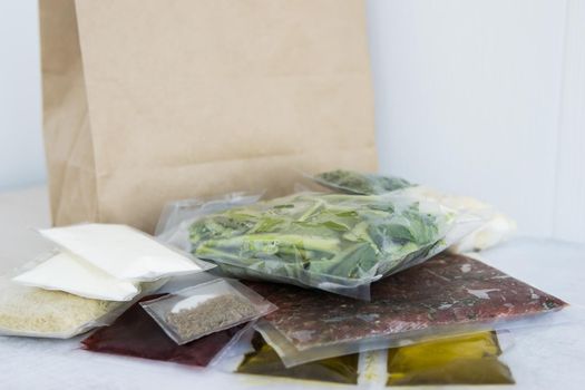 Set of products for dinner: minced meat, rice, spinach, celery, dill, olive oil, sauces and spices. Set for delivery of food for dinner on a light background. Cooking at home, home-cooked food.