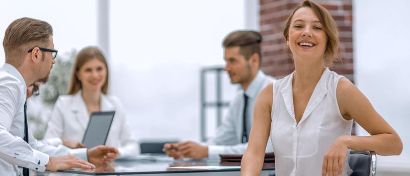 smiling employee and business team sitting at the Desk.the concept of teamwork