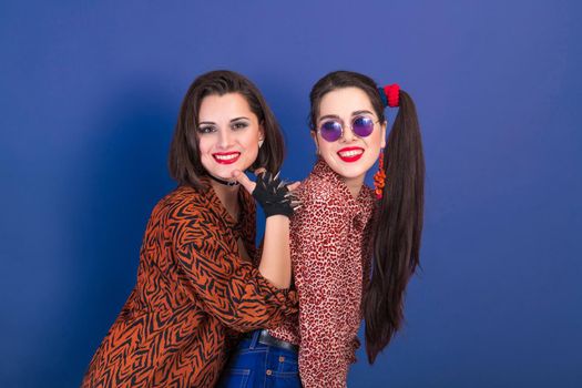 Portrait of two cheerful young women in 80s style.