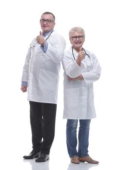 in full growth. two medical colleagues showing thumbs up. isolated on a white background