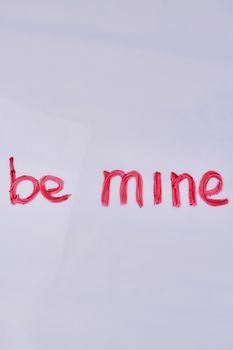 Top view of be mine hand-written love text. Copy space for text.