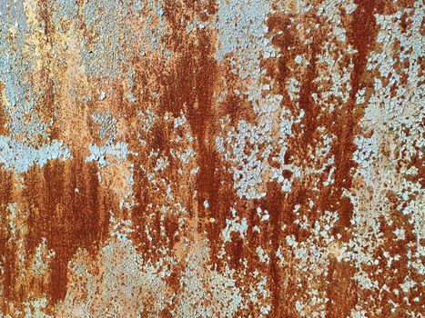 Corroded metal background. Rusted white painted metal wall. Rusty metal background with streaks of rust. Rust stains. The metal surface rusted spots. Rystycorrosion.