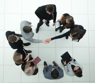 top view. financial partners confirming the transaction with a handshake. business concept