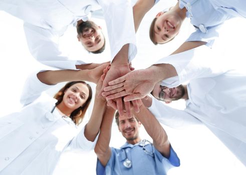 bottom view.a team of doctors at the medical center clasped their hands together.the concept of unity