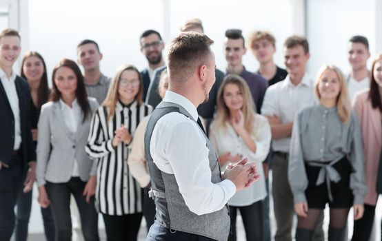 close up. a young leader looking at a happy business team