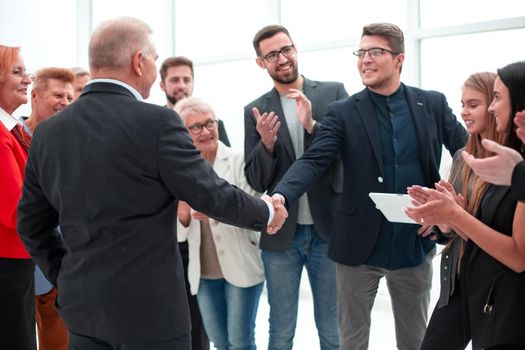 Businessmen making handshake in an office.