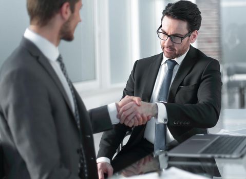 business people shaking hands over a Desk. the concept of unanimity