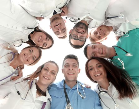 bottom view. diverse medical professionals standing in a circle. the concept of teamwork