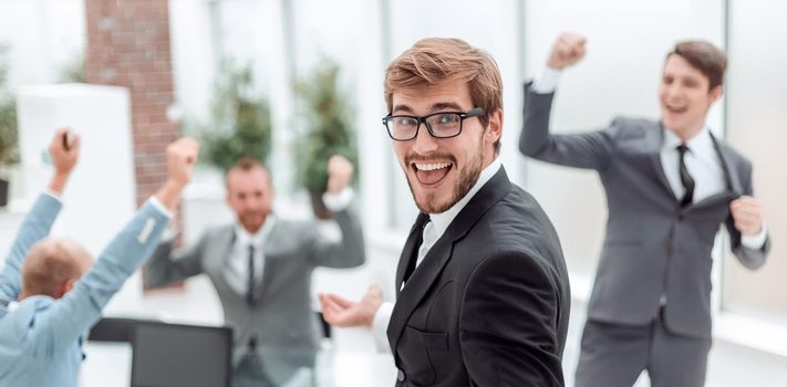 close up. happy boss standing in the office . photo with copy space