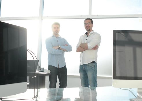 business background.two employees standing in a modern office. business concept