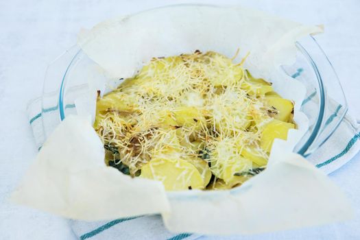 Potato casserole with cheese and herbs. Homemade food, cooking at home. Healthy food.