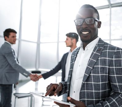 close up.young businessman standing in the office.people and technology