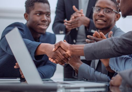 close up. young businessman shaking hands with his business partner